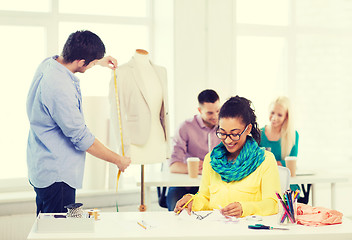 Image showing smiling fashion designers working in office