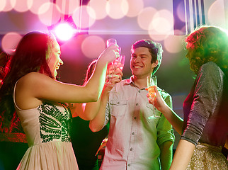 Image showing smiling friends with glasses of champagne in club