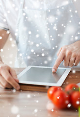 Image showing closeup of man reading recipe from tablet pc