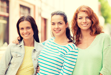 Image showing smiling teenage girls with on street