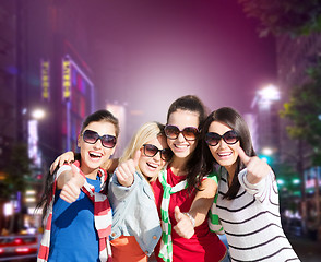 Image showing group of young women showing thumbs up in city