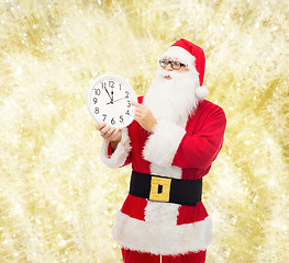 Image showing man in costume of santa claus with clock