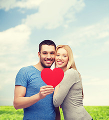 Image showing smiling couple holding big red heart