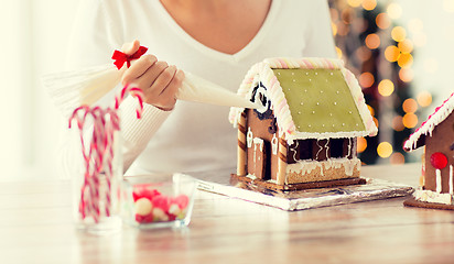 Image showing close up of woman making gingerbread houses