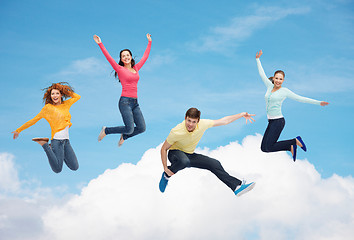 Image showing group of smiling teenagers jumping in air