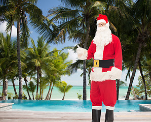 Image showing man in costume of santa claus showing thumbs up