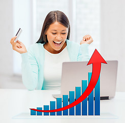 Image showing smiling woman with laptop computer and credit card