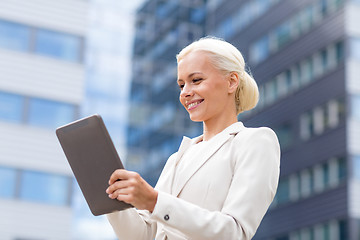 Image showing smiling businesswoman with tablet pc outdoors