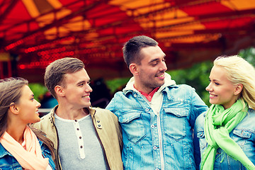 Image showing group of smiling friends in amusement park