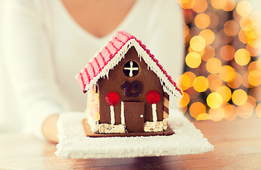 Image showing close up of woman showing gingerbread house