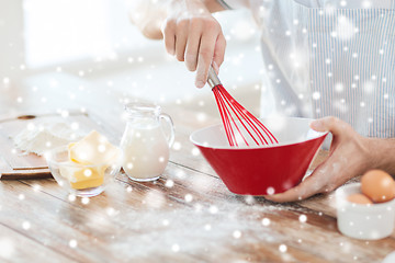 Image showing close up of man whipping something in bowl