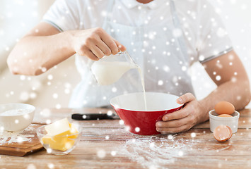 Image showing close up of man pouring milk into bowl