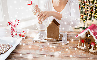 Image showing close up of woman making gingerbread houses