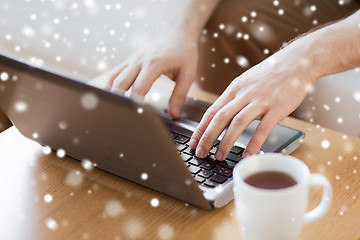 Image showing close up of man with laptop and coffee cup at home