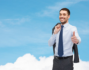 Image showing smiling young businessman showing thumbs up