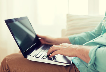 Image showing close up of man working with laptop at home