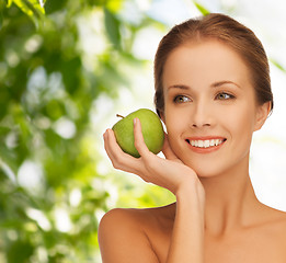 Image showing smiling young woman with green apple