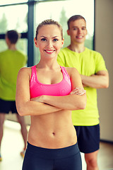 Image showing smiling man and woman in gym