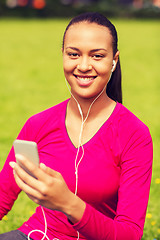 Image showing smiling african american woman with smartphone