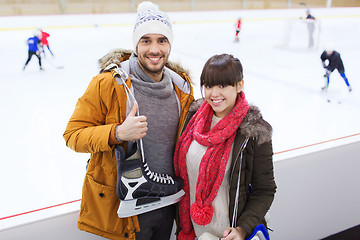 Image showing happy couple with ice-skates on skating rink
