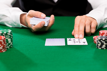 Image showing holdem dealer with playing cards and casino chips