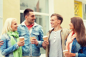 Image showing group of smiling friends with take away coffee