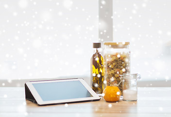 Image showing close up of tablet pc olive oil, pasta and pumpkin