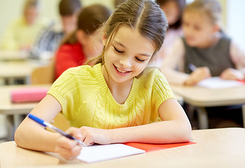 Image showing group of school kids writing test in classroom