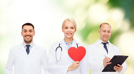 Image showing group of smiling doctors with red heart shape