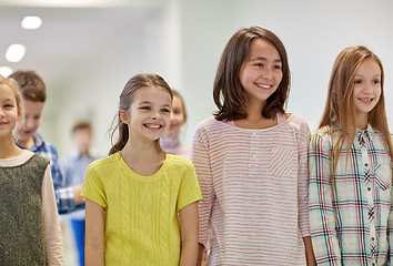 Image showing group of smiling school kids walking in corridor