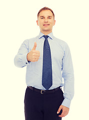 Image showing smiling businessman showing thumbs up