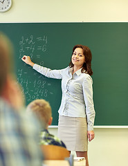 Image showing school kids and teacher writing on chalkboard