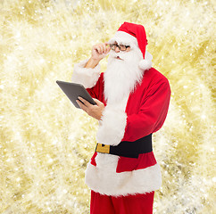 Image showing man in costume of santa claus with tablet pc