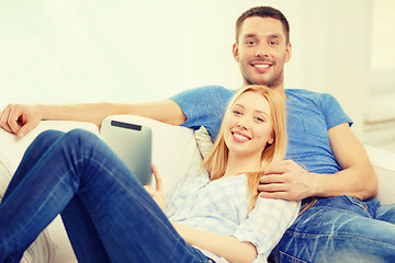 Image showing smiling happy couple with tablet pc at home