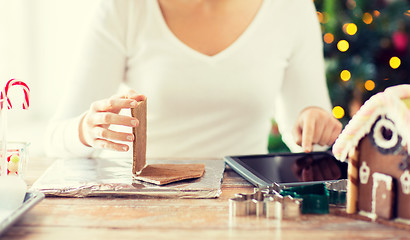 Image showing close up of woman making gingerbread houses