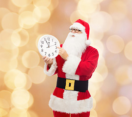 Image showing man in costume of santa claus with clock