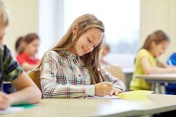 Image showing group of school kids writing test in classroom