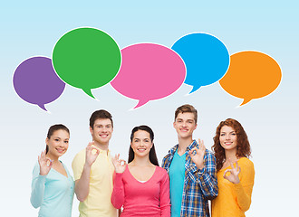 Image showing group of smiling teenagers showing ok sign