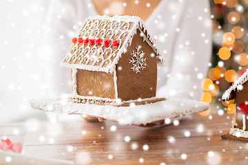 Image showing close up of woman showing gingerbread house