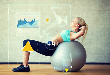 Image showing smiling woman with exercise ball in gym