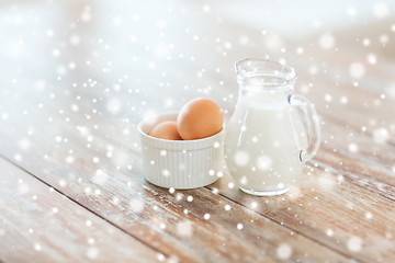 Image showing close up of milk jugful and eggs in bowl