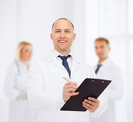 Image showing smiling male doctor with clipboard