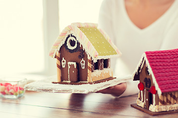 Image showing close up of woman showing gingerbread house