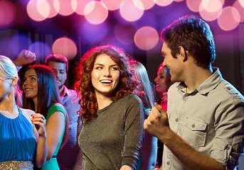 Image showing smiling friends dancing in club