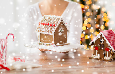 Image showing close up of woman showing gingerbread house