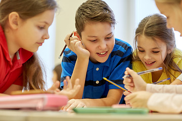 Image showing group of students talking and writing at school