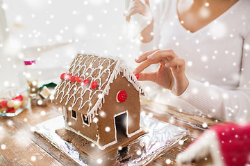 Image showing close up of woman making gingerbread houses