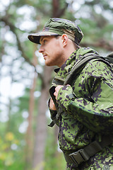 Image showing young soldier with backpack in forest