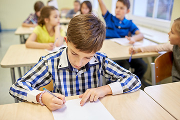 Image showing group of school kids writing test in classroom