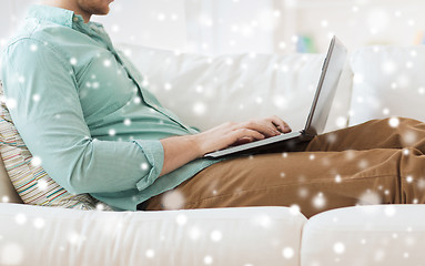 Image showing close up of man working with laptop at home